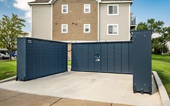 A large blue garage door in front of a two-story building